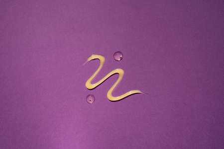 Liquid gel cosmetic product on violet background. cosmetic product textureの写真素材