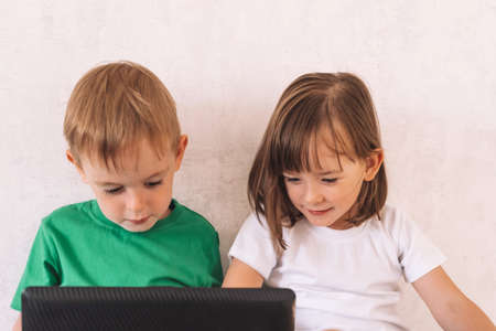 Children use laptop while sitting at homeの写真素材