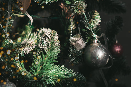 Silver and pink Christmas decorations on the Christmas tree and twinkling lights. Holiday and new year concept. copy spaceの写真素材