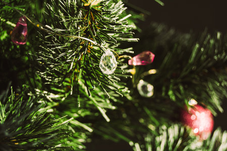 Close-up, elegant garland in the form of drops on a Christmas tree, copy space. Christmas and new year concept.の写真素材
