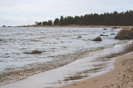 Sandy shore with stones in the bay. Nature landscape.の写真素材