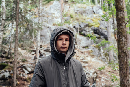 A free and confident man in nature, around trees and rocks. Healthy natural lifestyle - happiness emotion.の写真素材