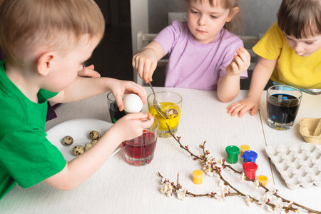 Children color eggs with food coloring. Getting ready for Easterの写真素材