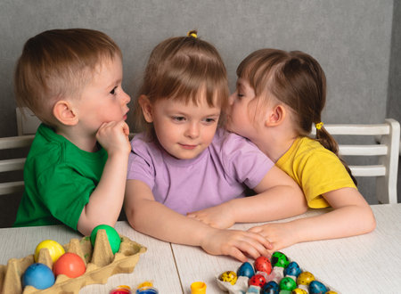 Children paint eggs and talk. Getting ready for Easter.の写真素材
