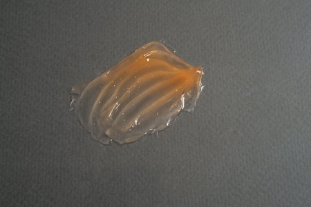 Smear of transparent orange cosmetic product. Texture background and selfcare trendの写真素材