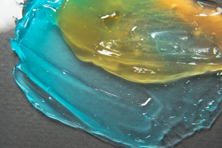 Close-up texture of face and body cosmetic product. Samples of a multicolored cosmetic product on a gray background. selfcare trendsの写真素材