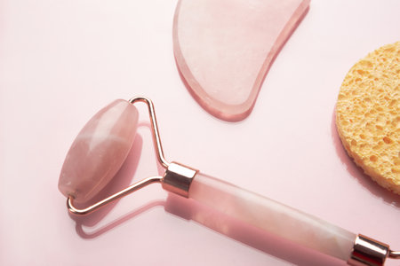 Close-up face and body skin care accessories. Quartz roller, gua sha massage scraper and facial spongesの写真素材