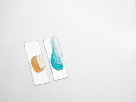 Samples of a multicolored cosmetic product on a laboratory glass on a white background. self care...
