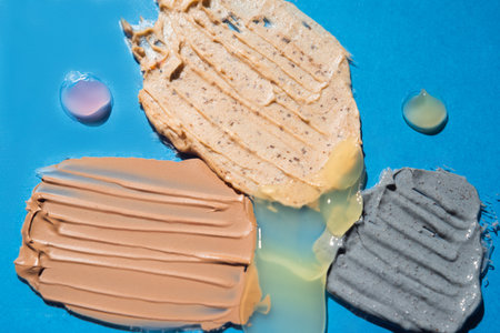 Closeup samples of cosmetic products on blue background. Self-care trendの写真素材