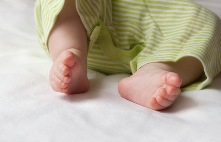 Baby foots on the sheetの写真素材