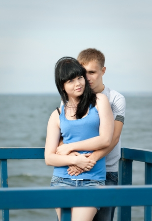 loving young couple is embracing at sea berthの写真素材