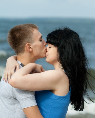 Guy is kissing his girlfriend outdoorsの写真素材