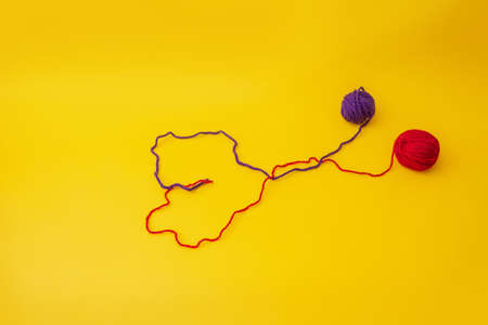 untangled from the tangle of red and blue threads intertwining form a heart o