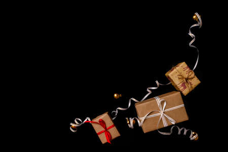gifts for Christmas, wrapped in wrapping paper and tied with a ribbon, next to the Golden Christmas...