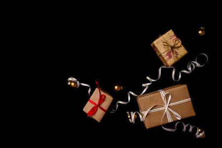 gifts for Christmas, wrapped in wrapping paper and tied with a ribbon, next to the Golden Christmas...
