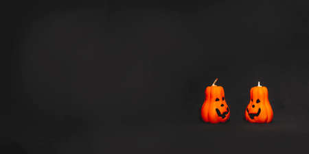 Orange pumpkin candles with Jack's face on  blackの写真素材