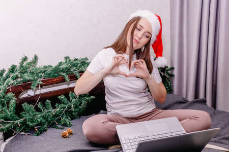 a young happy brunette wishes her family and friends a happy new year and Christmas over the...