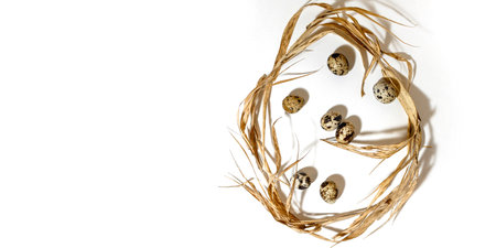 The Easter egg shape is made of eggs and straw. Minimal holiday concept. Flat ley, top view. ......