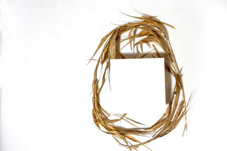 The shape of the Easter egg is made of straw. Minimal holiday concept. Flat lay, top view.の写真素材