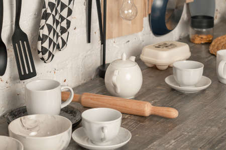 cups, kitchen utensils, rolling pin, on the kitchen table.の写真素材