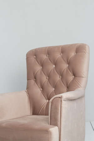 a classic pink armchair sits in a white room on a wooden floor. copy space.の写真素材
