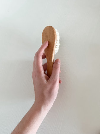 a woman's hand holds a baby hair dryer on a white background.の写真素材