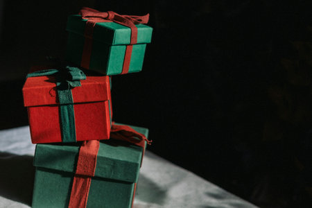 A mountain of gifts stands on a table with a white tablecloth. Contrast photography. Preparing...