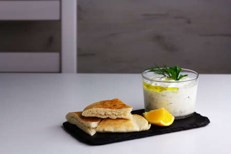 Traditional greek sauce tzatziki in a glass bowlの写真素材