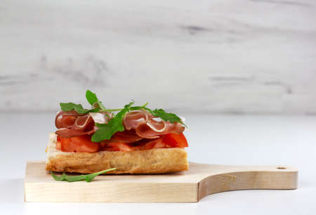 Tapas with spanish hamon or bruschetta with italian proscuitto on ight background, copy spaceの写真素材