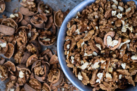 Walnuts kernels with color background, Whole walnut in a metal plate. Walnuts. Walnuts an market. Background of walnuts. Healthy. Freshの写真素材