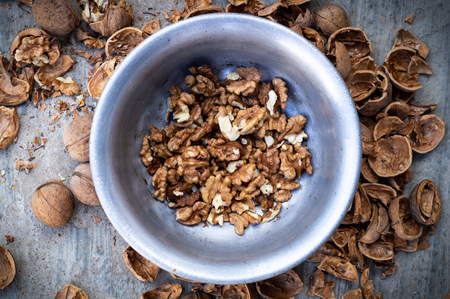 Walnuts kernels with color background, Whole walnut in a metal plate. Walnuts. Walnuts an market. Background of walnuts. Healthy. Freshの写真素材