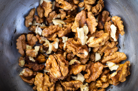Walnuts kernels with color background, Whole walnut in a metal plate. Walnuts. Walnuts an market. Background of walnuts. Healthy. Freshの写真素材