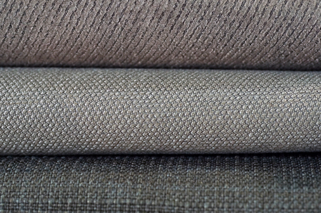 Catalogue of multicoloured cloth from matting fabric texture background.