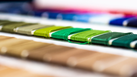 Catalog of threads. Multicolored furniture threads. Textile industry background with blurred. Macro, concept of design. Productionの写真素材