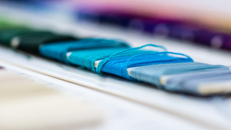 Catalog of threads. Multicolored furniture threads. Textile industry background with blurred. Macro, concept of design. Productionの写真素材