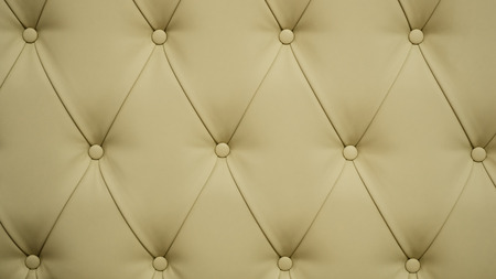 Coach-type leatherette screed tightened with buttons. Natural chesterfield style quilted upholstery backdrop close up. background textureの写真素材