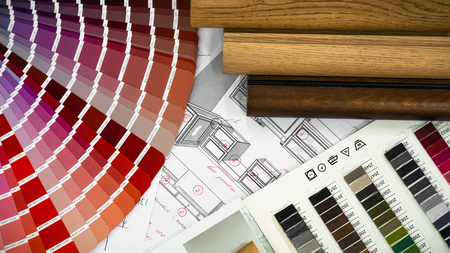 Architectural blueprint interior with wooden and paper samples and a multi-colored palette and draw...