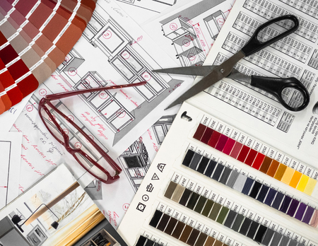Architectural blueprint interior with wooden and paper samples and a multi-colored palette and draw toolsの写真素材