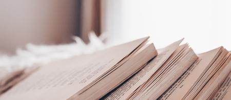 Chaotic stack of old books pastel colors, selective focus with copy space.Background from books. Books close upの写真素材
