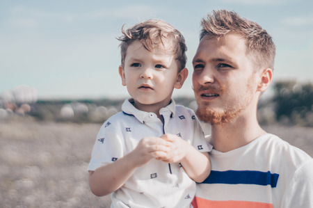 Happy loving family. Father and his son baby boy playing and hugging outdoors. Concept of Father's day.の写真素材
