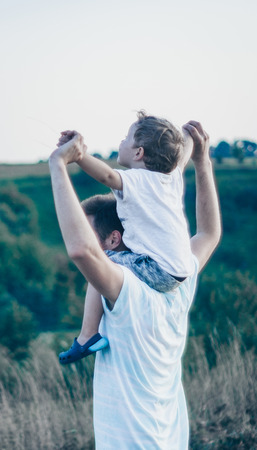 Happy loving family. Father and his son baby boy playing and hugging outdoors. Concept of Father's day.の写真素材