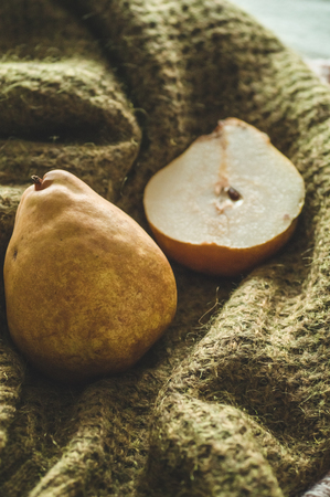 Autumn nature concept. Fall pears on knitted sweaters. Thanksgiving dinner.の写真素材