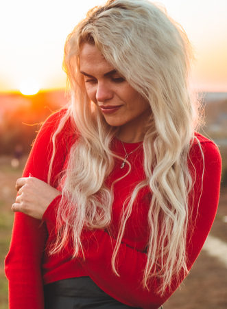 Beauty Romantic Girl Outdoors enjoying nature. Beautiful autumn model with waving glow hair. Sun light on sunset. Portrait of romantic femaleの写真素材