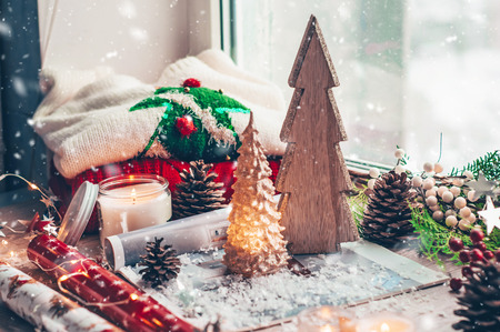 Christmas decor, Christmas wooden tree, Warm sweater, led string lights, candy, candles and Christmas tree. Winter mood, holiday decoration.の写真素材
