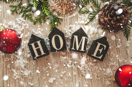 Home decorations in the wooden background of a letter with an inscription home. Christmas...