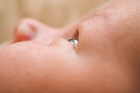 Cute newborn infant baby boy asleep wrapped in a soft  plaid. Parts of the body of a small child. Love baby. Newborn baby and mother.の写真素材
