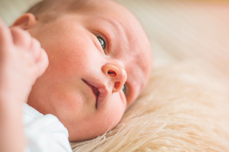 Cute newborn infant baby boy asleep wrapped in a soft  plaid. Love baby. Newborn baby and mother.の写真素材
