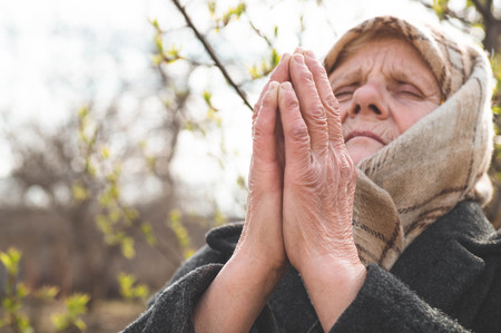 Grandmother pray for faith spirituality and religion. Asking God for good luck, success,...