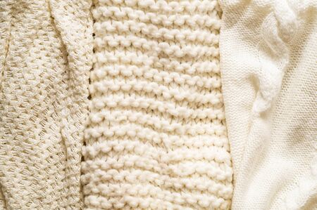 Fall Background with warm sweaters. Pile of knitted clothes. Warm background, knitwear, space for text, Autumn winter concept. Copy Space.の写真素材