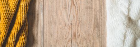 Fall Background with warm sweaters. Pile of knitted clothes. Warm background, knitwear, space for text, Autumn winter concept. Copy Space.の写真素材